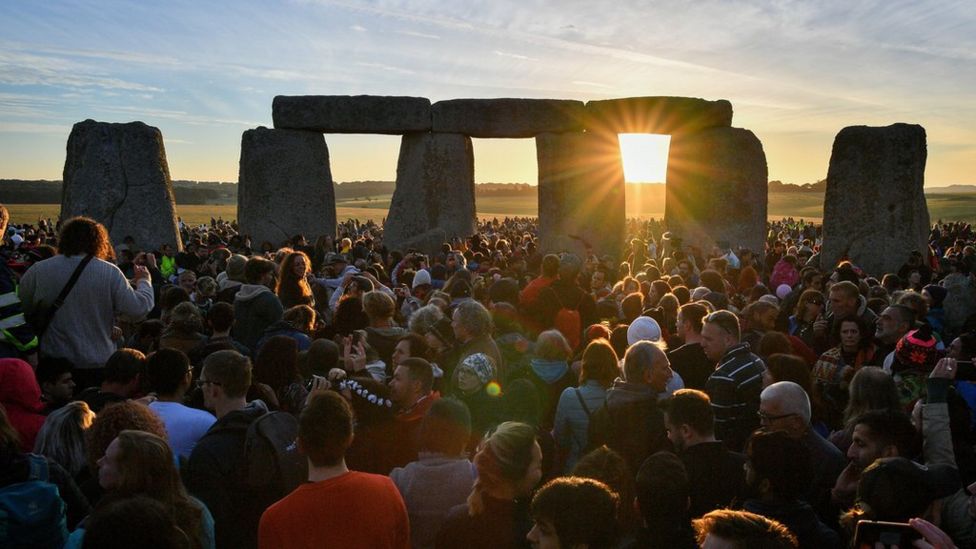 People celebrating Summer Solstice at Stonehenge.